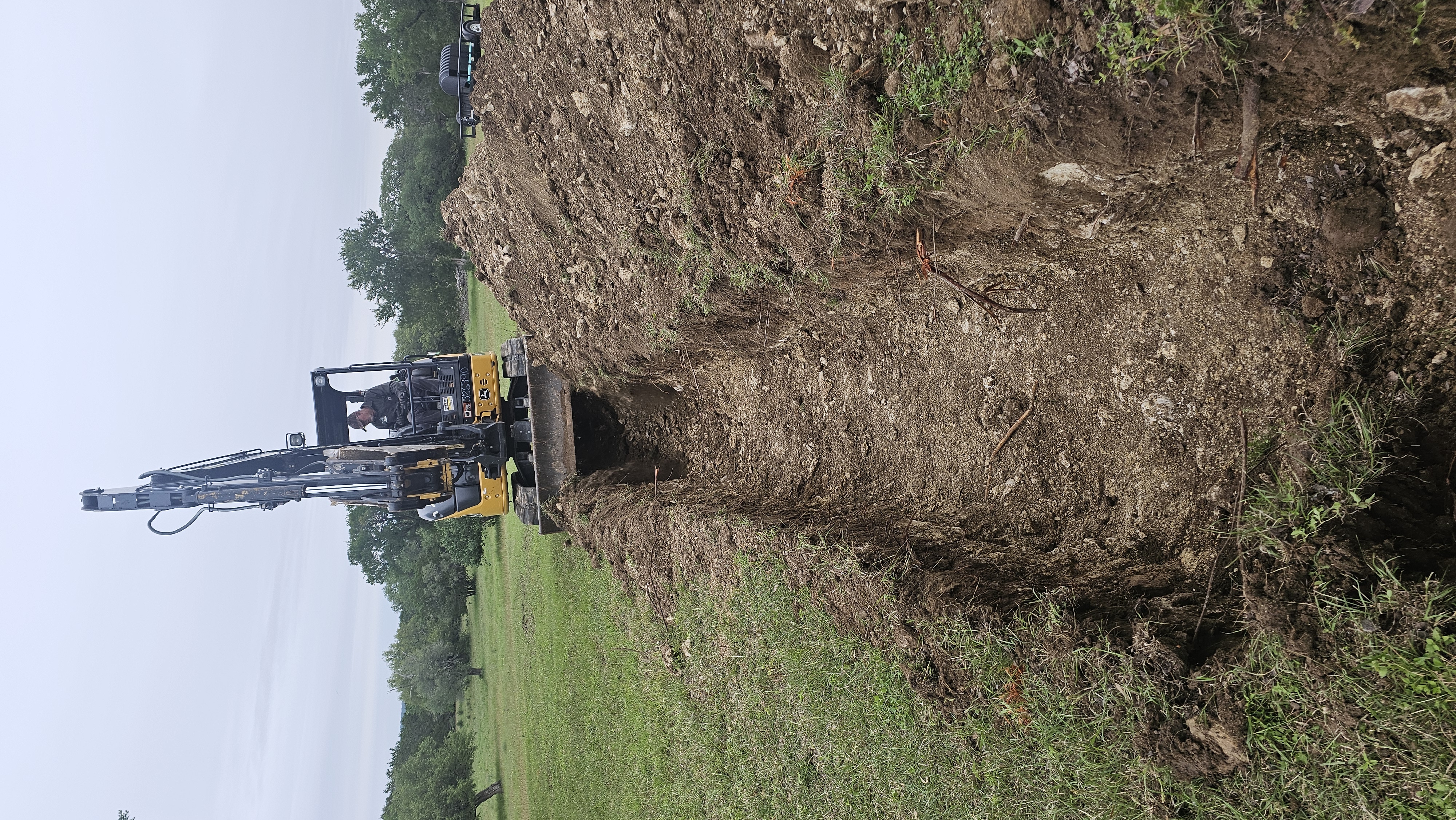 Excavator digging for new septic leach field